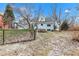 Sloping back yard with a black chain link fence at 12404 Doe Ln, Indianapolis, IN 46236