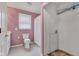 Functional bathroom featuring a toilet, shower with curtain, and adjacent laundry area at 12404 Doe Ln, Indianapolis, IN 46236