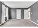 Bedroom with plush carpet, two closets and a large window with white curtains at 12404 Doe Ln, Indianapolis, IN 46236