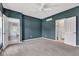 Inviting bedroom with teal walls, neutral carpet, ceiling fan and en-suite bathrooms to other rooms at 12404 Doe Ln, Indianapolis, IN 46236