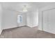 White bedroom with neutral carpet, overhead light fixture, and closet with double doors at 12404 Doe Ln, Indianapolis, IN 46236