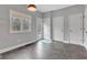 Bright entryway with gray tile flooring, natural light and access to exterior and interior doors at 12404 Doe Ln, Indianapolis, IN 46236