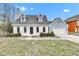 Charming Cape Cod featuring a brick and blue exterior, dormer windows and a well-maintained front yard at 12404 Doe Ln, Indianapolis, IN 46236
