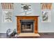 Living room fireplace with a decorative mantle, flanked by two windows with matching valances at 12404 Doe Ln, Indianapolis, IN 46236