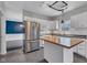 Kitchen with stainless steel appliances, a butcher block island, and a view into the dining room at 12404 Doe Ln, Indianapolis, IN 46236