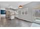 Bright kitchen boasts white cabinets, stainless steel appliances, island, and natural light from the window at 12404 Doe Ln, Indianapolis, IN 46236