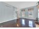 Bright living room features hardwood floors, large windows, and staircase at 12404 Doe Ln, Indianapolis, IN 46236