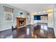 Cozy living room with a fireplace, and dark hardwood flooring, perfect for relaxation at 12404 Doe Ln, Indianapolis, IN 46236