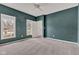Bright primary bedroom featuring neutral carpet, modern ceiling fan, and natural light from two windows at 12404 Doe Ln, Indianapolis, IN 46236