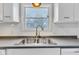 Close-up of the kitchen sink and countertop featuring a goose neck faucet at 12404 Doe Ln, Indianapolis, IN 46236