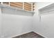 Walk-in closet featuring built-in storage shelves, closet rod, and neutral carpet at 12404 Doe Ln, Indianapolis, IN 46236
