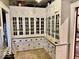 Spacious butler's pantry offers ample storage with beautiful glass-front cabinets and drawers at 1300 W University Ave, Muncie, IN 47303