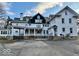 Elegant white home featuring a covered entrance, manicured lawns, and a spacious driveway at 1300 W University Ave, Muncie, IN 47303