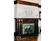 Elegant fireplace features a dark wood mantle, green tile surround, and black hearth at 1300 W University Ave, Muncie, IN 47303