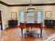 Front foyer featuring a beautiful piano, elegant lighting, and decorative wall art at 1300 W University Ave, Muncie, IN 47303