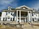 Stately home with imposing columns, multiple windows, and green roof creating a stunning facade at 1300 W University Ave, Muncie, IN 47303