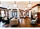 Spacious living room with herringbone floors, modern furniture, and elegant lighting fixtures at 1300 W University Ave, Muncie, IN 47303