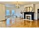 Spacious living room with hardwood floors, fireplace, bay window, and built-in seating at 1300 W University Ave, Muncie, IN 47303