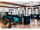 Salon featuring multiple styling stations with chairs, mirrors, and hardwood floors at 1300 W University Ave, Muncie, IN 47303