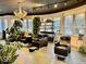 A salon space with chairs and wash basins beneath a decorative chandelier and shelves of product at 1300 W University Ave, Muncie, IN 47303