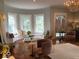 Elegant sitting area with bay windows, a window seat, chandelier, and stylish furnishings at 1300 W University Ave, Muncie, IN 47303