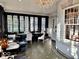 Sunroom with black-framed windows, crystal chandelier, and seating at 1300 W University Ave, Muncie, IN 47303
