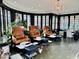 Bright sunroom with high-backed chairs, manicure stations, and black framed windows at 1300 W University Ave, Muncie, IN 47303