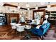 Inviting sitting area with a fireplace, modern furniture, herringbone wood floors and elegant lighting at 1300 W University Ave, Muncie, IN 47303