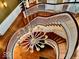 Sweeping staircase featuring wood steps and a vintage style chandelier at 1300 W University Ave, Muncie, IN 47303