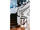 Detailed view of the staircase showcasing dark wood steps and decorative wallpaper at 1300 W University Ave, Muncie, IN 47303