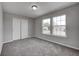 Bedroom with neutral walls and carpet, brightened by two windows and a closet at 13115 N Departure W Blvd, Camby, IN 46113