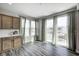 Bright breakfast nook with wood floors, natural light, and adjacent kitchen cabinets at 13115 N Departure W Blvd, Camby, IN 46113