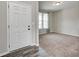 Home entryway with a white door and light gray walls; a doorway leads to a carpeted room with natural light at 13115 N Departure W Blvd, Camby, IN 46113