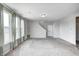 Bright, airy living room with light gray walls and carpeted floor; natural light streams through the large windows at 13115 N Departure W Blvd, Camby, IN 46113