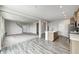 Open-concept living area with a kitchen island, hardwood floors, and carpeted stairs at 13115 N Departure W Blvd, Camby, IN 46113