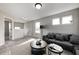 Bright, open living room featuring large windows, neutral walls and carpet, and a cozy seating arrangement at 13115 N Departure W Blvd, Camby, IN 46113