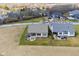 Expansive aerial view showcasing the home's backyard, patio, and lush surroundings at 16392 Grand Cypress Dr, Noblesville, IN 46060