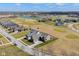 Panoramic aerial view of a neighborhood with well-manicured lawns, a pond, and a golf course at 16392 Grand Cypress Dr, Noblesville, IN 46060