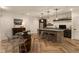 Basement bar area with a barrel table, stylish stools, lighting, and beverage fridge at 16392 Grand Cypress Dr, Noblesville, IN 46060