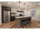 Basement bar with a granite countertop, brick base, stainless steel fridge, and shelving at 16392 Grand Cypress Dr, Noblesville, IN 46060