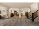 Open basement featuring a bar, kitchenette, stairs to the main floor, and neutral decor at 16392 Grand Cypress Dr, Noblesville, IN 46060