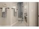 This bathroom features a glass shower door, neutral tile, and a view into the toilet room at 16392 Grand Cypress Dr, Noblesville, IN 46060