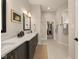 This elegant bathroom features double sinks, modern fixtures, a large vanity, and a walk-in closet at 16392 Grand Cypress Dr, Noblesville, IN 46060