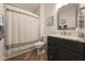 Modern bathroom with a marble vanity, dark wood cabinets, and a shower with striped curtain at 16392 Grand Cypress Dr, Noblesville, IN 46060