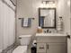 This bathroom features a vanity with a dark countertop, a framed mirror, and a toilet area at 16392 Grand Cypress Dr, Noblesville, IN 46060