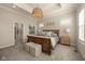 This bedroom features a wood sleigh bed, soft neutral colors, and a pair of upholstered ottomans at 16392 Grand Cypress Dr, Noblesville, IN 46060