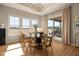 The dining room features large windows, access to outdoor living, and a modern chandelier at 16392 Grand Cypress Dr, Noblesville, IN 46060