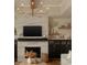 Stylish fireplace with marble surround, custom cabinets, floating shelves, and modern lighting at 16392 Grand Cypress Dr, Noblesville, IN 46060