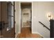 View of the foyer with hardwood floors and a hall tree with bench and storage baskets at 16392 Grand Cypress Dr, Noblesville, IN 46060