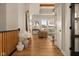Bright hallway with hardwood floors that leads to a living room with a view of the exterior at 16392 Grand Cypress Dr, Noblesville, IN 46060